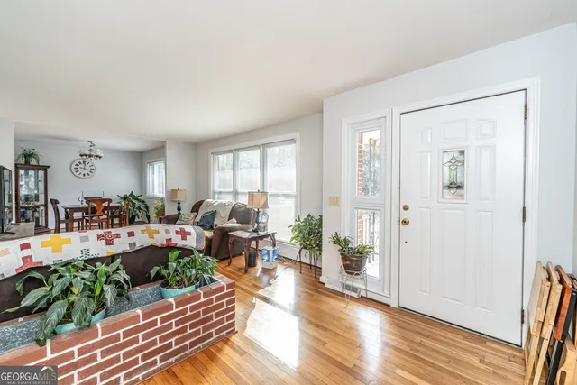 a living room with furniture dining room and wooden floor