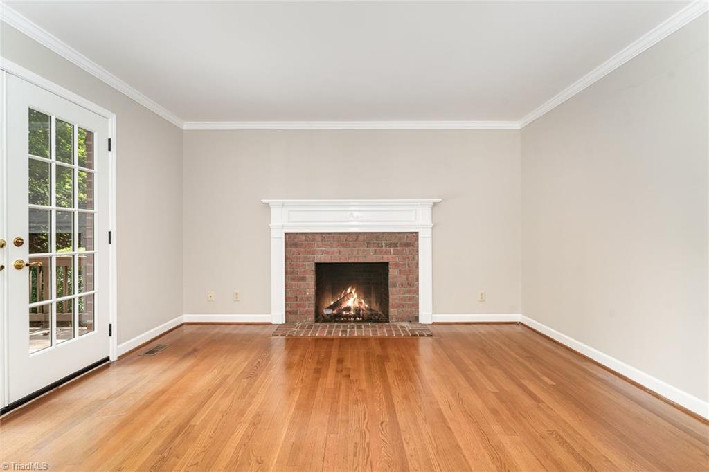 4107 Rockingham Road South Greensboro, NC 27407 - Photo 20 of 50 Den has fireplace and abundant natural lights; connects to sunroom and back deck