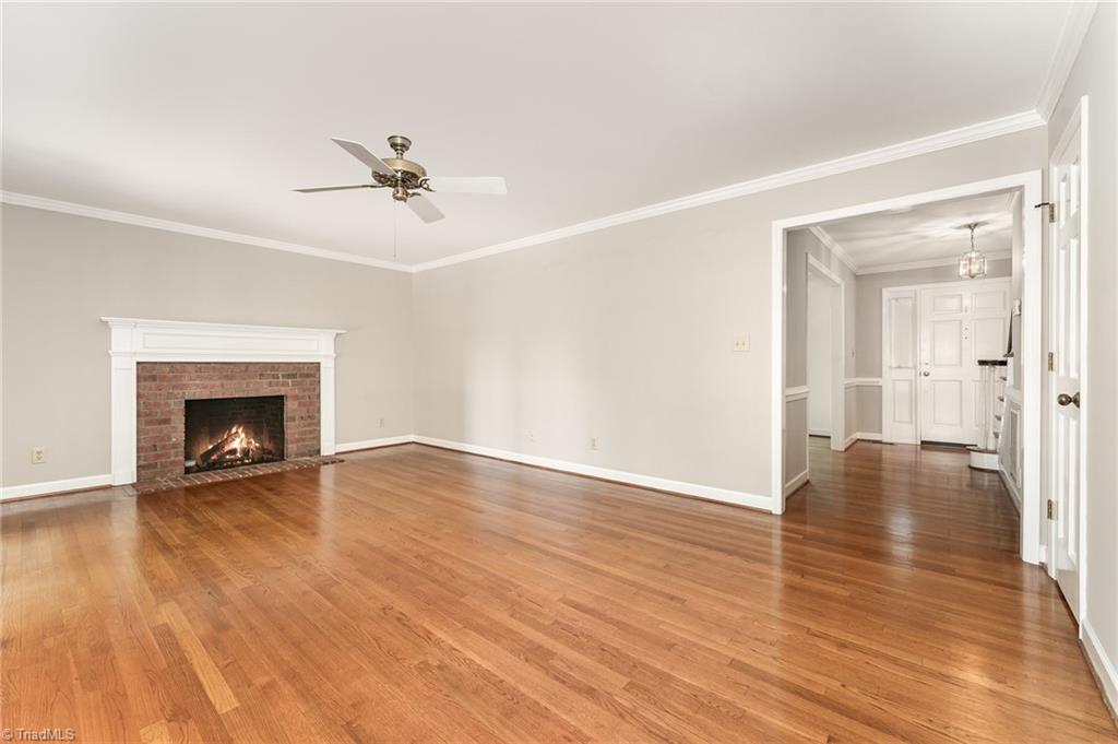 4107 Rockingham Road South Greensboro, NC 27407 - Photo 21 of 50 Den has fireplace and abundant natural lights; connects to sunroom and back deck