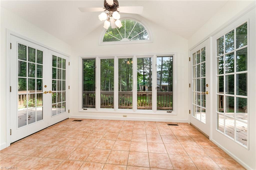 4107 Rockingham Road South Greensboro, NC 27407 - Photo 23 of 50 Bright sunroom looking into the private backyard and deck