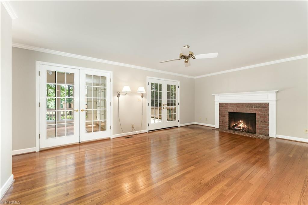 4107 Rockingham Road South Greensboro, NC 27407 - Photo 4 of 50 Den has fireplace and abundant natural lights; connects to sunroom and back deck
