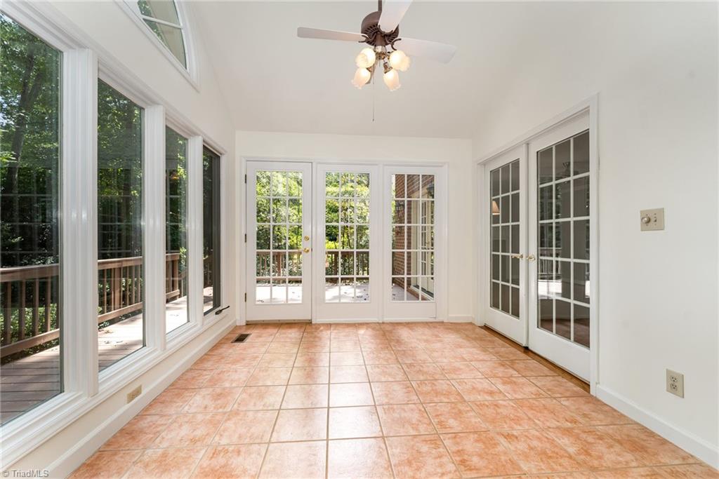 4107 Rockingham Road South Greensboro, NC 27407 - Photo 5 of 50 Bright sunroom looking into the private backyard and deck
