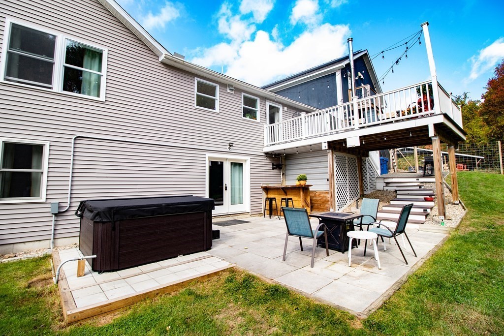 96 Cold Hill Granby, MA 01033 - Photo 12 of 42 a view of a house with patio and a yard