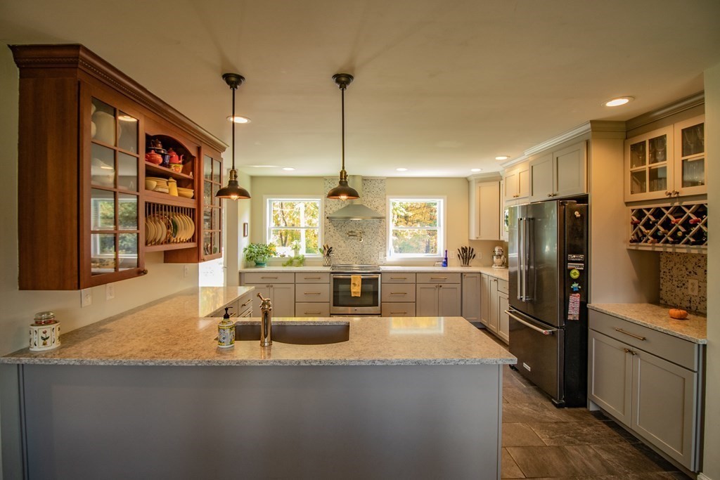 96 Cold Hill Granby, MA 01033 - Photo 19 of 42 a kitchen with stainless steel appliances granite countertop a sink a stove and refrigerator