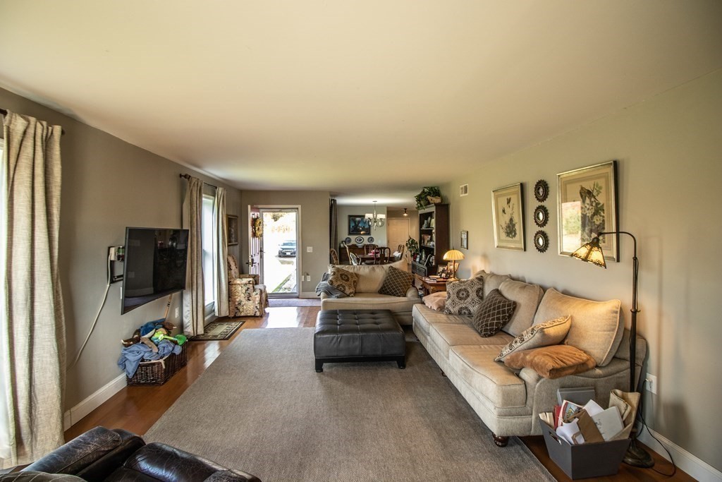 96 Cold Hill Granby, MA 01033 - Photo 26 of 42 a living room with furniture fireplace and a flat screen tv