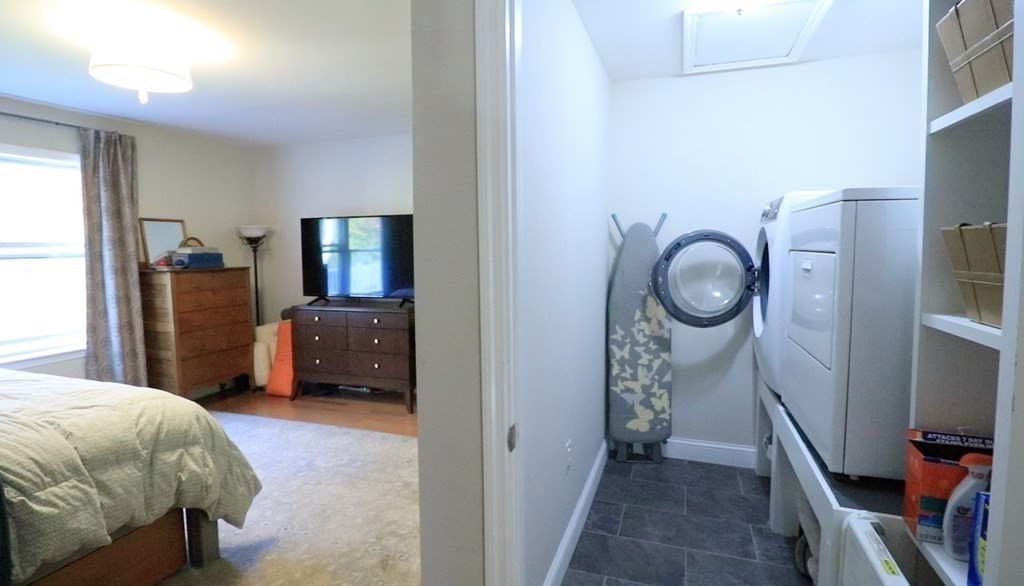 96 Cold Hill Granby, MA 01033 - Photo 29 of 42 a bedroom with a bed closet and a flat tv screen