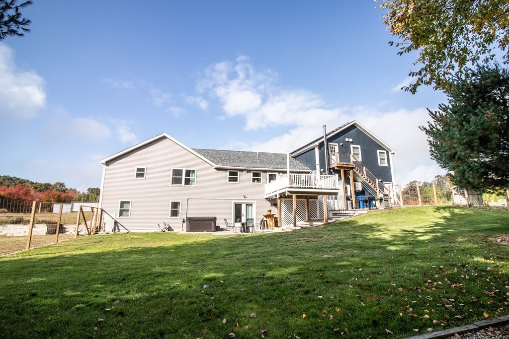 96 Cold Hill Granby, MA 01033 - Photo 7 of 42 a view of a white house in front of a big yard with plants and large trees