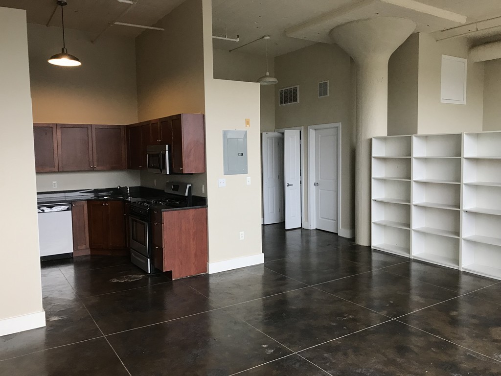21 Illinois Street, Unit 402 Worcester, MA 01610 - Photo 11 of 16 a kitchen with stainless steel appliances a refrigerator and a stove top oven