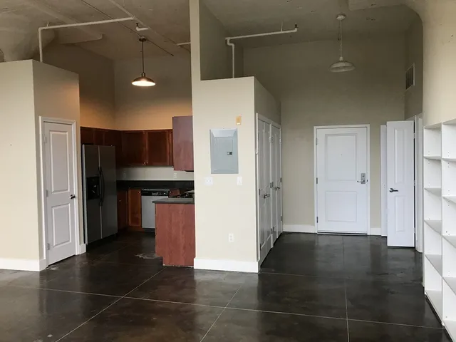 a view of a refrigerator in kitchen and a counter top space