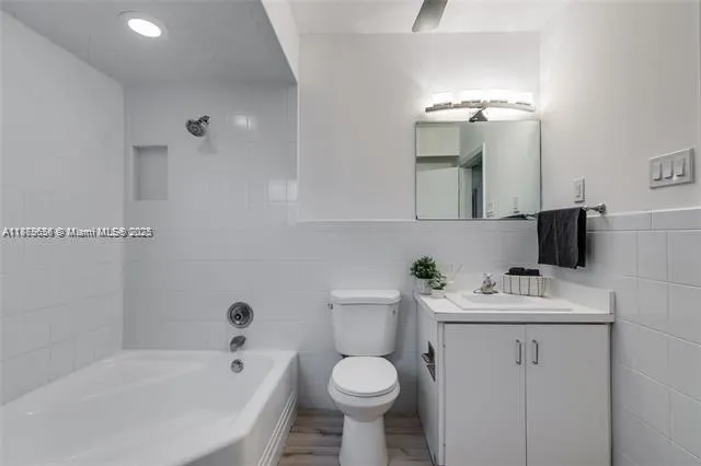 a bathroom with a sink toilet and tub