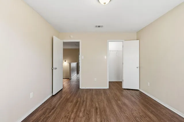 a view of hallway with wooden floor