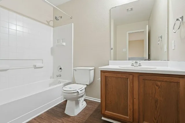 a bathroom with a sink a toilet and a large mirror