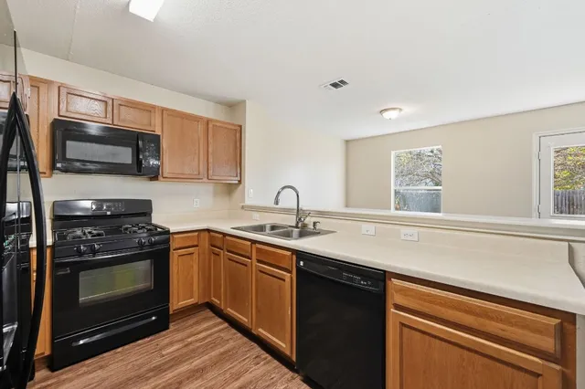 a kitchen with a sink stove and microwave