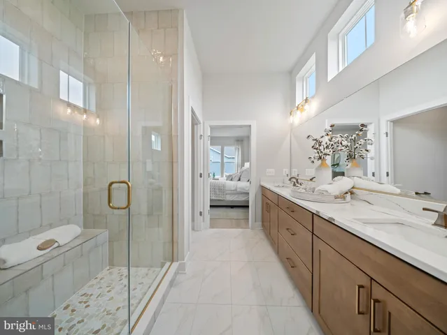 a en suite bathroom with a double vanity sink and a mirror