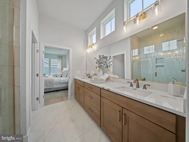 a bathroom with double vanity sinks and a mirror