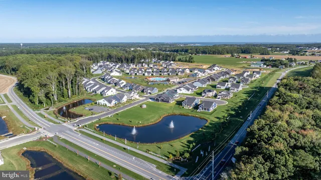 an aerial view of a house with a swimming pool outdoor seating and yard