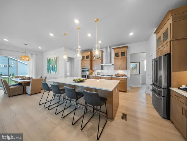 a kitchen with stainless steel appliances kitchen island a stove and a refrigerator