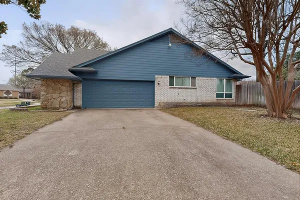 a front view of house with yard and trees