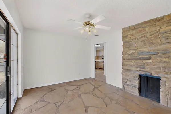 wooden floor in an empty room with a fireplace