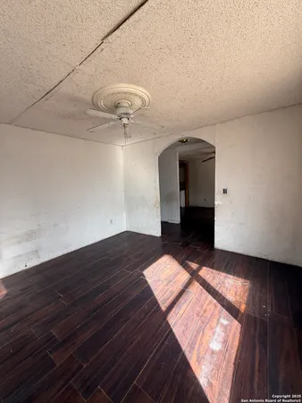 a view of a room with wooden floor and staircase