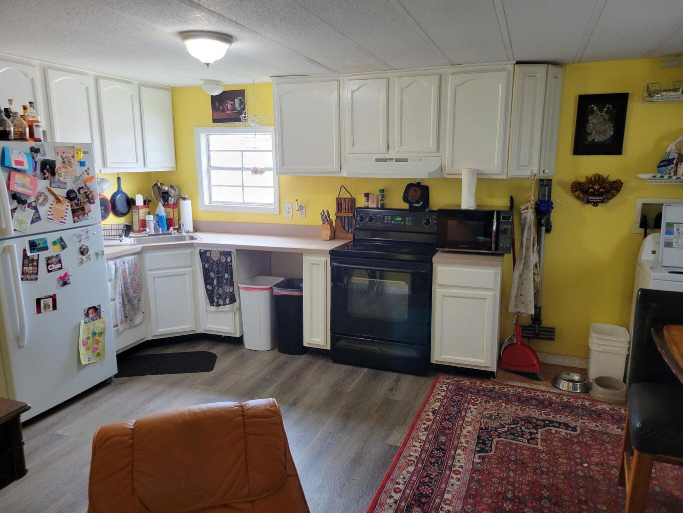 C1 9th Avenue Key West, FL 33040 - Photo 4 of 8 a kitchen with stainless steel appliances granite countertop a stove a sink and a microwave
