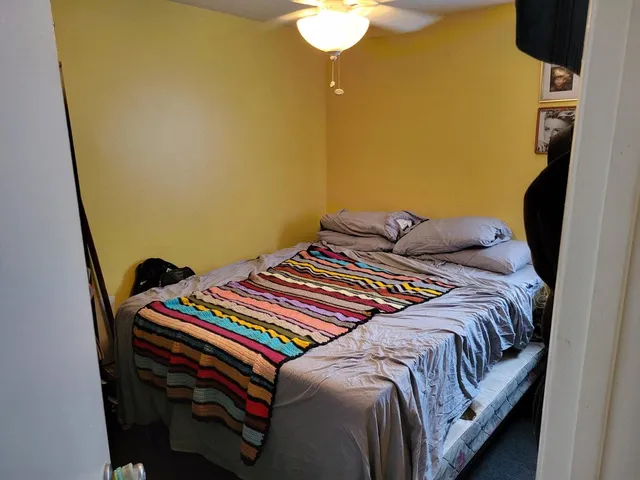 a bedroom with a bed and a mirror