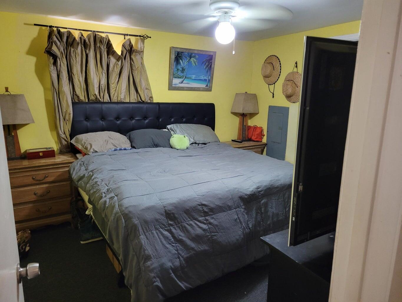 C1 9th Avenue Key West, FL 33040 - Photo 8 of 8 a bedroom with a bed and a painting on the wall