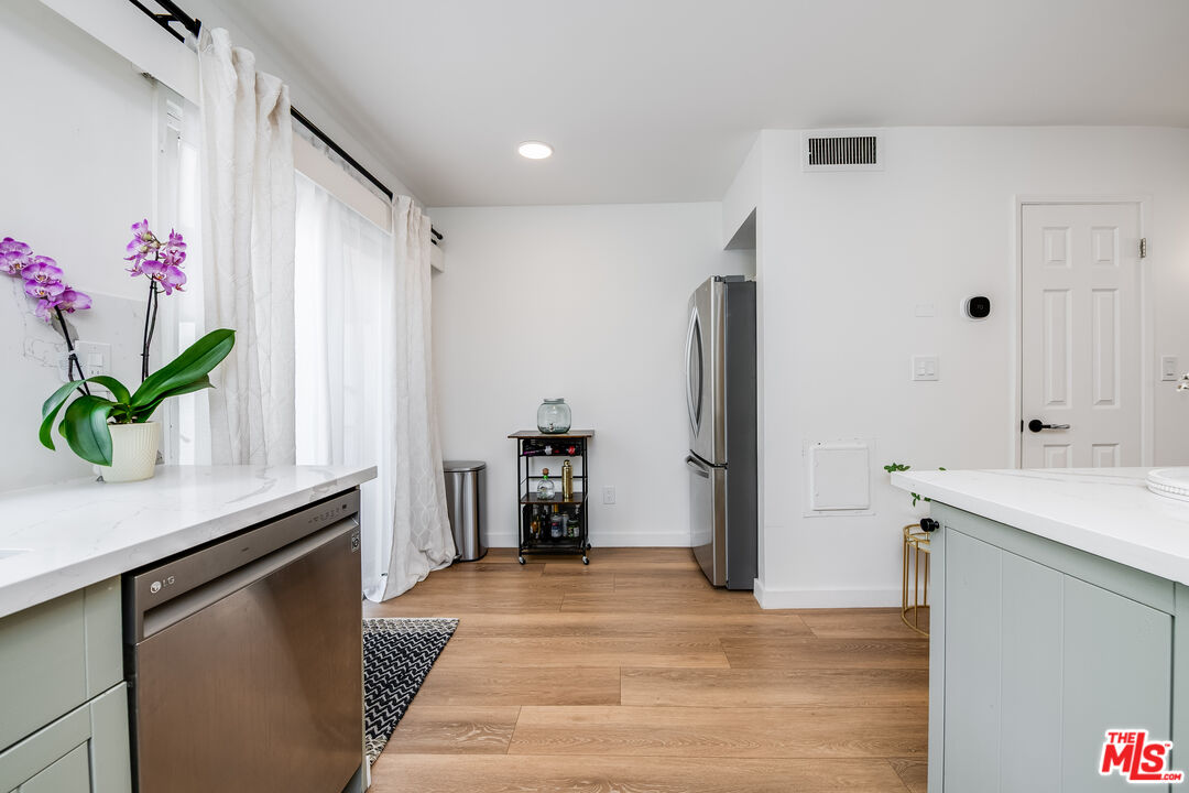 4558 Willis Avenue, Unit 121 Sherman Oaks, CA 91403 - Photo 12 of 34 a kitchen with stainless steel appliances granite countertop a refrigerator and a sink