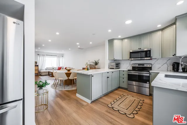 a kitchen with a sink stainless steel appliances and cabinets