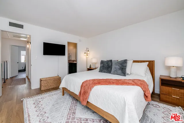 a bedroom with a bed and a television