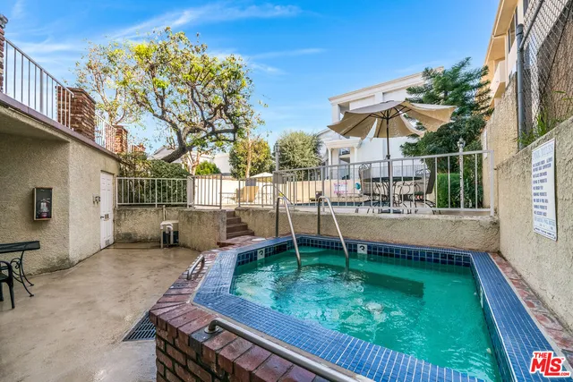 a view of a house with swimming pool and sitting area