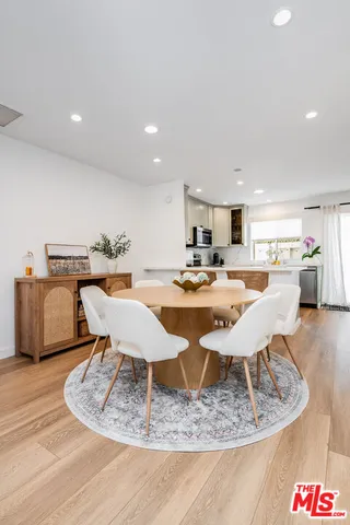 a living room with dining table and chairs