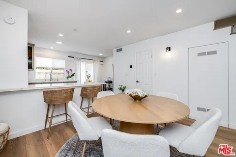 a kitchen with a table and chairs in it
