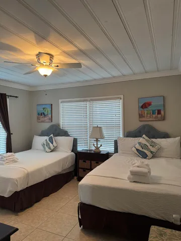 a bedroom with two beds and a lamp