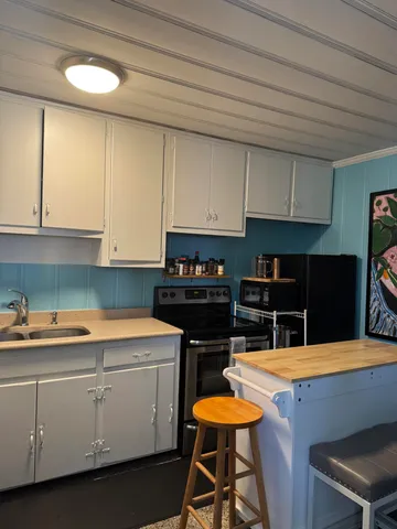 a kitchen with cabinets and appliances