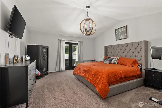 a bedroom with a bed and flat screen tv