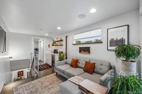 a living room with furniture potted plant and a window