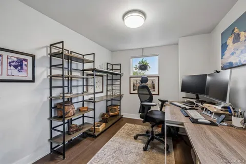 a view of a workspace with furniture and a window