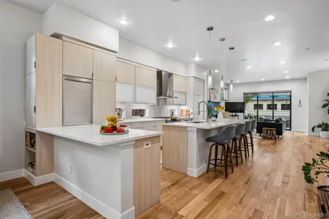 a kitchen with white cabinets and sink