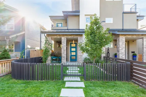 a front view of a house with a garden and plants