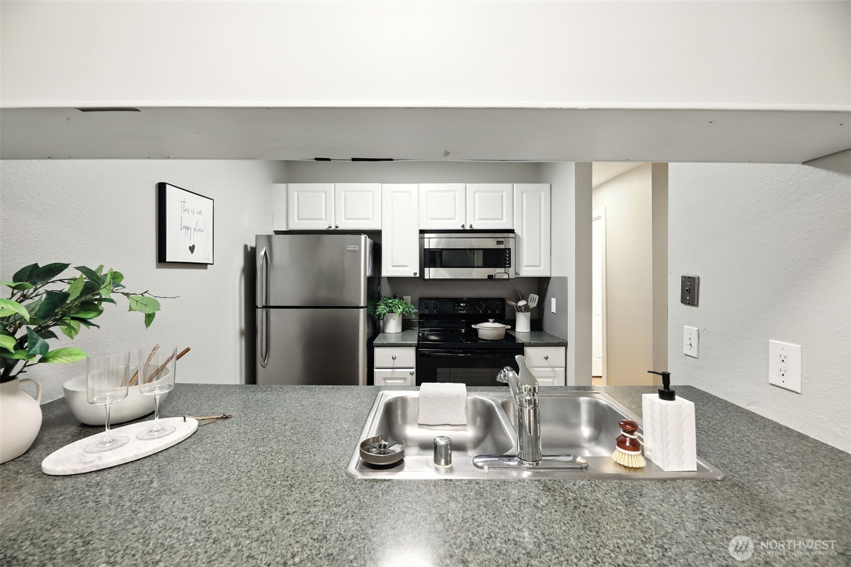 3233 Northeast 12th Street, Unit 207 Renton, WA 98056 - Photo 13 of 40 a kitchen with a refrigerator and a counter top space