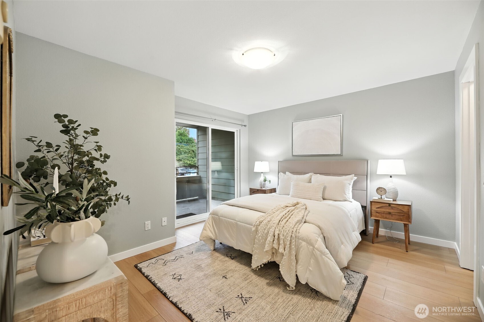 3233 Northeast 12th Street, Unit 207 Renton, WA 98056 - Photo 18 of 40 a bedroom with a bed and a potted plant