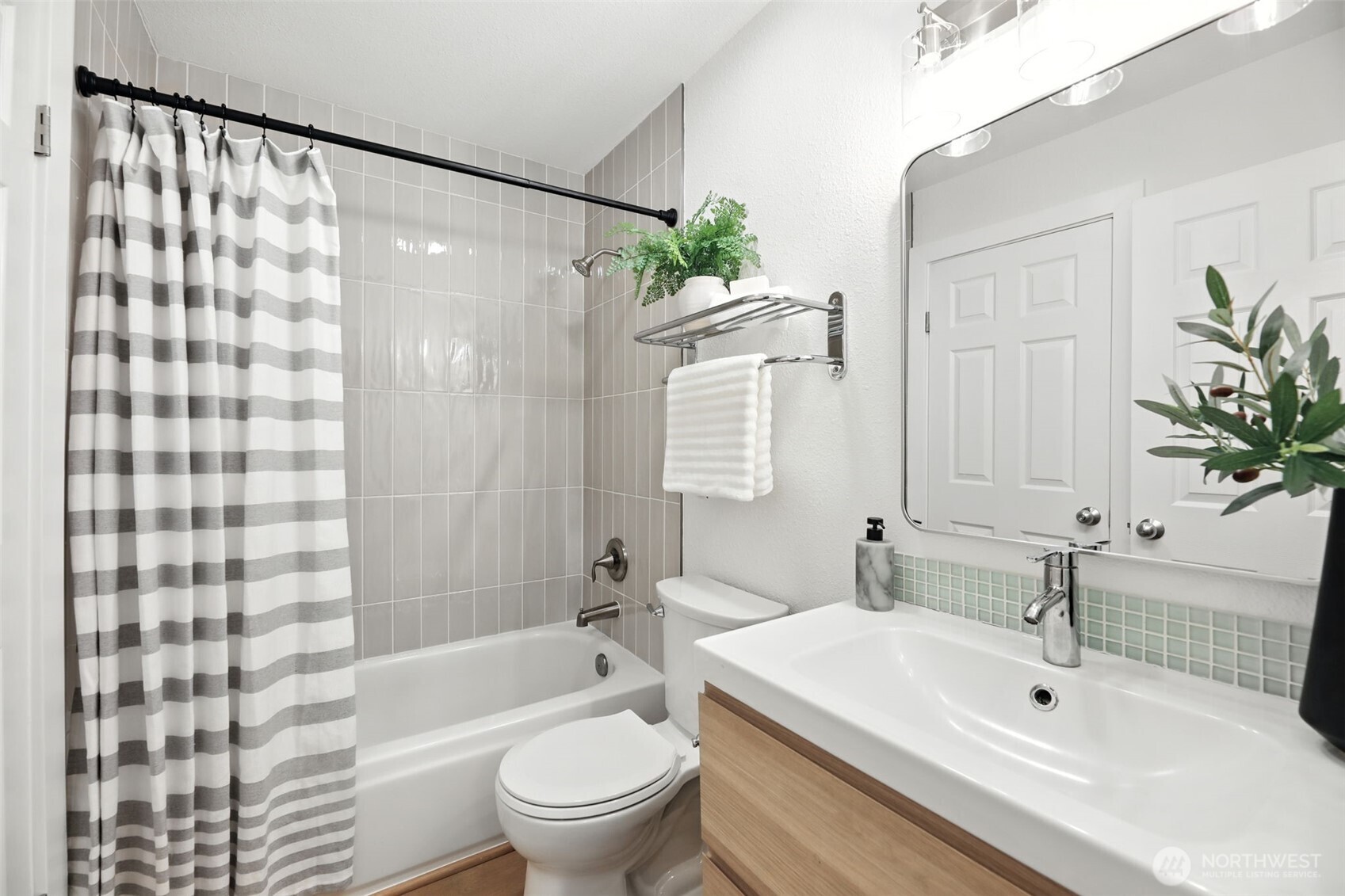 3233 Northeast 12th Street, Unit 207 Renton, WA 98056 - Photo 22 of 40 a bathroom with a bathtub shower sink mirror and toilet