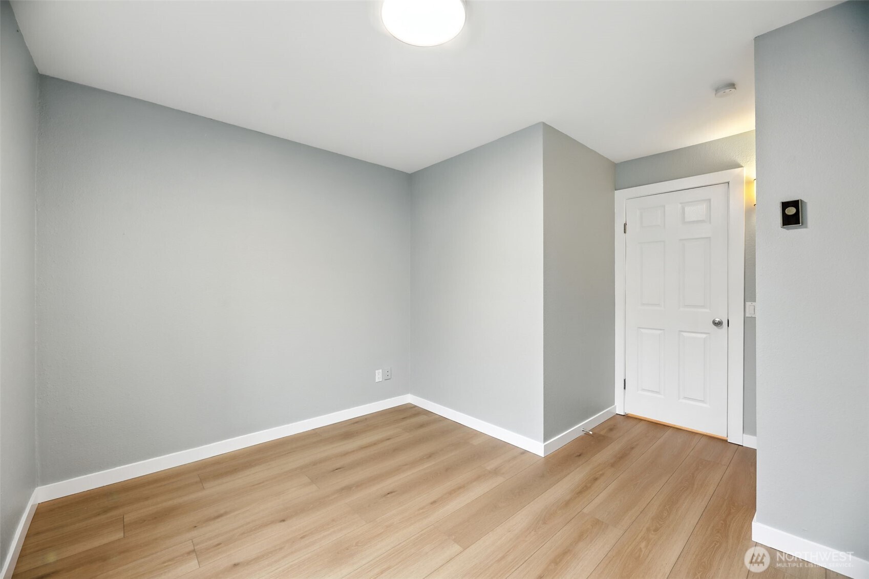 3233 Northeast 12th Street, Unit 207 Renton, WA 98056 - Photo 24 of 40 a view of an empty room with wooden floor