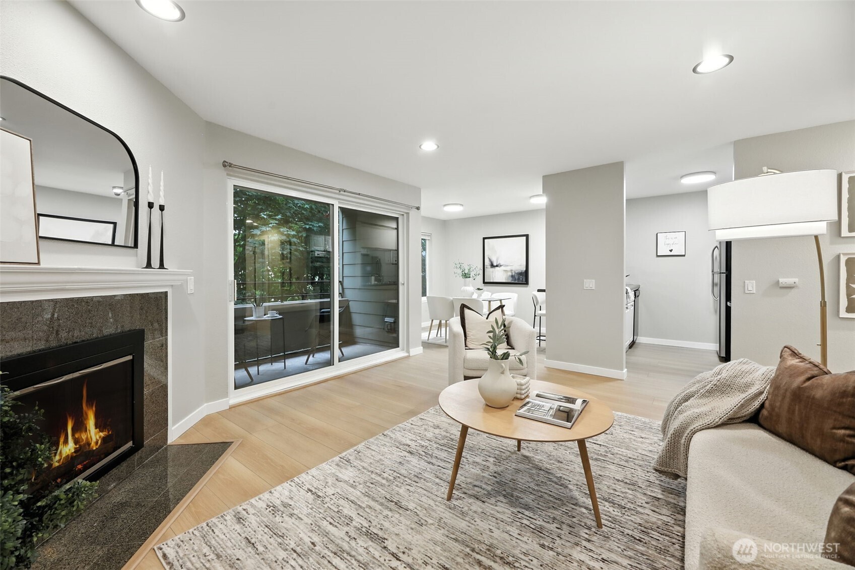 3233 Northeast 12th Street, Unit 207 Renton, WA 98056 - Photo 9 of 40 a living room with furniture a fireplace and a table