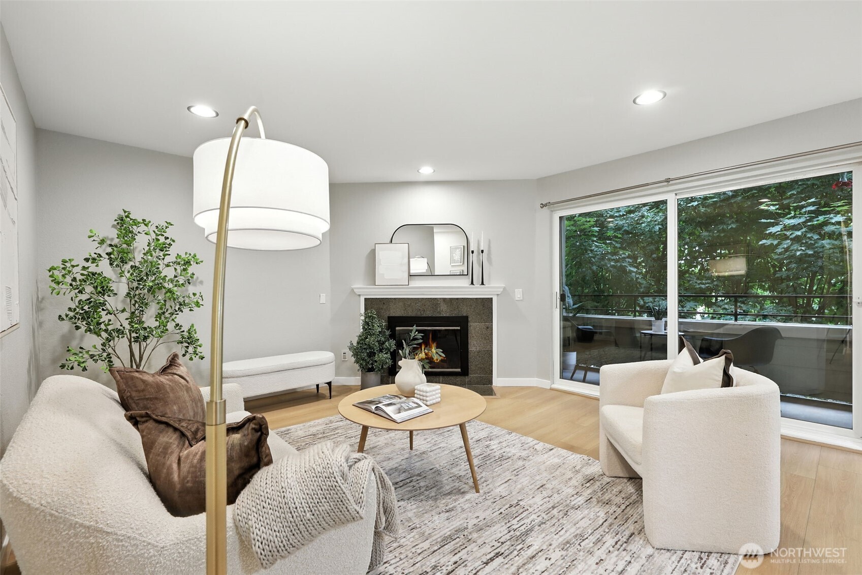 3233 Northeast 12th Street, Unit 207 Renton, WA 98056 - Photo 10 of 40 a living room with furniture a large window and a fireplace