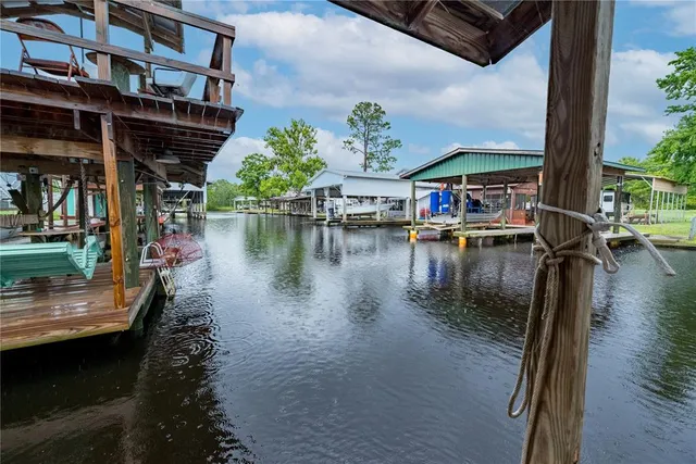 a view of a room with wooden floor and windows