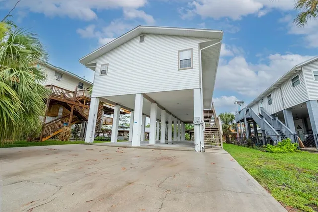 a view of a house with a yard and sitting area