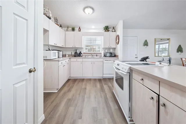 a view of a livingroom with furniture window and wooden floor