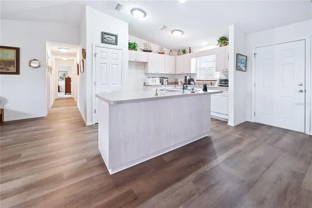 a bathroom with a granite countertop sink a toilet and a mirror